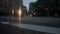 Low view of crossing a crosswalk in New York City at night. Cars driving into the intersection at NYC