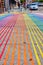 Low view of rainbow crosswalk in Castro District on bright sunny day