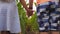 Low view of small girl and boy standing at corn field and taking each other hands. Couple of little kids holding arms at