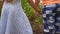 Low view of small girl and boy standing at corn field and taking each other hands. Couple of little kids holding arms at