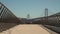 A low view straight down Pier 14 in San Francisco looking toward the Bay Bridge