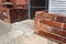 Low wall of mixed recycled brick and block before a locked chain link entrance