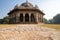 Low, wide angle view of Isa Khans Garden Tomb, part of Humayan`s Tomb Complex