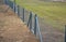 a low wire fence separates the individual small grassy areas of