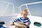 Lower the anchor. Adventure boy sailor travelling sea. Child cute sailor help with ropes yacht bow. Baby boy enjoy