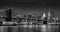 Lower Manhattan Financial District skyscrapers, Brooklyn Bridge, and East River. at twilight in Black & White. Manhattan, New York