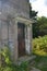 Lower part of an old watchtower of a former GDR border fortification with a rusted door