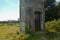 Lower part of an old watchtower of a former GDR border fortification with a rusted door