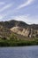 Lower Sand Cove pond and green reeds with white and yellow sandstone hills