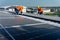 Lower view with panel as foreground, two Caucasian technician workers work with install the solar cell panels on rooftop of
