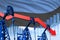Lowering, falling graph on Estonia flag background - industrial illustration of Estonia oil industry or market concept. 3D