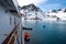 Lowering orange lifeboat to water in Arctic waters, Svalbard. Abandon ship drill. Lifeboat training. Man over board drill