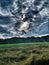 Lowering sky in Upper Austria in field with grass and trees