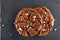 Lowkey picture of two chocolate cookies on dark background, close-up, shallow depth of field