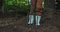 Lowsection of african american boy holding garden fork in garden