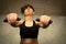 LoYoung woman doing a toning exercise with pulley