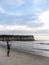 Luanda, Angola - April 26, 2014: Recreational young fisherman standing at beach north of Luanda angling, Angola, Africa