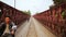 LUANG PRABANG,LAOS - APRIL 2014: motorbikes crossing historical iron bridge