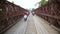 LUANG PRABANG,LAOS - APRIL 2014: motorbikes crossing historical iron bridge