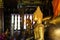 LUANG PRABANG WAT XIENG THONG, LAOS - DECEMBER 17. 2017: Buddha statues inside temple illuminated by natural sunlight
