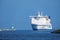 Lubeck, Germany, March 3, 2022: Large ferry boat between the lighthouse and the Priwall shore entering the port of Lubeck