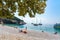 Lubenice beach with tousist and ships in Cres island Croatia with crystal clear turquoise water and atree shade