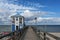 LUBMIN, GERMANY, SEPTEMBER 05, 2020: Sea-bridge with lifeguard station house under a blue sky with clouds, seaside tourist resort