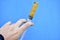 Lubricants in a syringe in your hand on a blue background