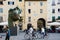 LUCCA, ITALY - OCTOBER 5, 2017: Couple with bicycles walk the famous square amphitheater Square (Piazza Anfiteatro) near big head