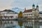 LUCERNE, SWITZERLAND - November, 2018: View of the Mount Pilatus, Jesuitenkirche and houses  on the embankment of the Reuss river