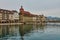 LUCERNE, SWITZERLAND - November 29, 2018: View of the City Hall, Water Tower, Wooden Chapel Bridge, and houses  on the embankment