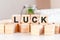 Luck concept with wooden blocks and coins on table, business concept