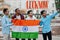 Lucknow city inscription. Group of four indian male friends with India flag making selfie on mobile phone. Largest India cities