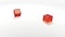 Lucky dice rolling. Red transparent cubes falling on the white mirror table of the casino in slow motion.