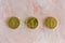 Lucky gold chocolate coins on pink background
