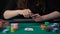 Lucky lady player showing hand, aces pair combination, poker competition, casino