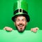 Lucky Patricks day. Man on green background celebrate St Patricks Day. Man in Saint Patrick`s Day leprechaun party hat