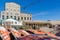 Luderitz, Namibia - July 08 2014: Red wooden boats and oyster and seafood traps stacked at colonial building