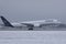 Lufthansa Airbus plane taxiing on runway, snow