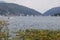 Lugano lake landscape with swiss mountain in background and sailboats on lake, Switzerland