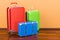 Luggage, baggage, colorful suitcases in room on the wooden floor