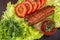 Lulia kebab on a salad with tomatoes and dill