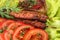 Lulia kebab on a salad with tomatoes and dill