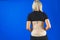Lumbar brace on the human body isolated on a blue background. Trauma of back. Back brace, orthopedic lumbar, support