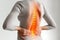 Lumbar intervertebral spine hernia, woman with back pain on a gray background, spinal disc disease, health problems concept, AI