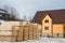 Lumber warehouse in the open air. Wooden beam, planks of wood, stacked in stacks. Construction material