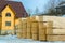 Lumber warehouse in the open air. Wooden beam, planks of wood, stacked in stacks. Construction material