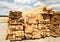 Lumber warehouse in the open air. Wooden beam, planks of wood, stacked in stacks. Sunny day, blue sky with clouds