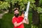 Lumberjack with chainsaw on forest background. Lumberjack holding the chainsaw. Logging. Deforestation is a major cause