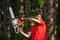 Lumberjack concept. Lumberjack with chainsaw in his hands. Logging. Illegal logging continues today. Lumberjack with